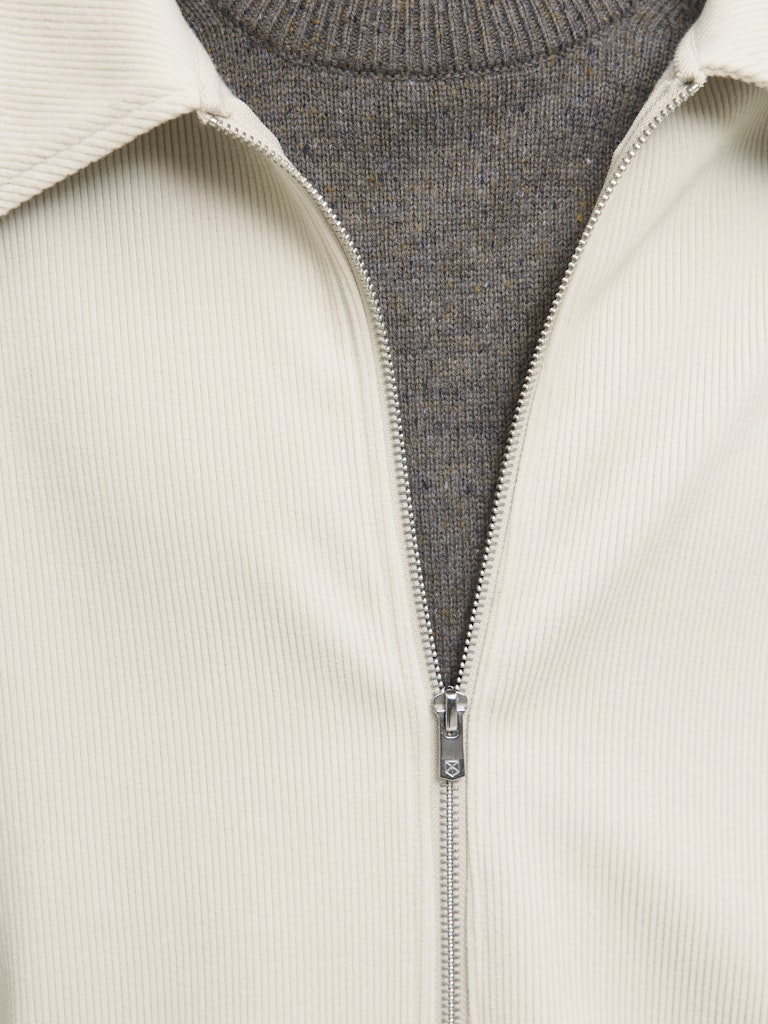 Man wearing a beige cardigan overshirt-zip detail