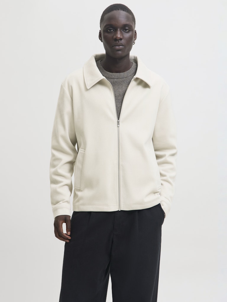 Man wearing a beige cardigan overshirt