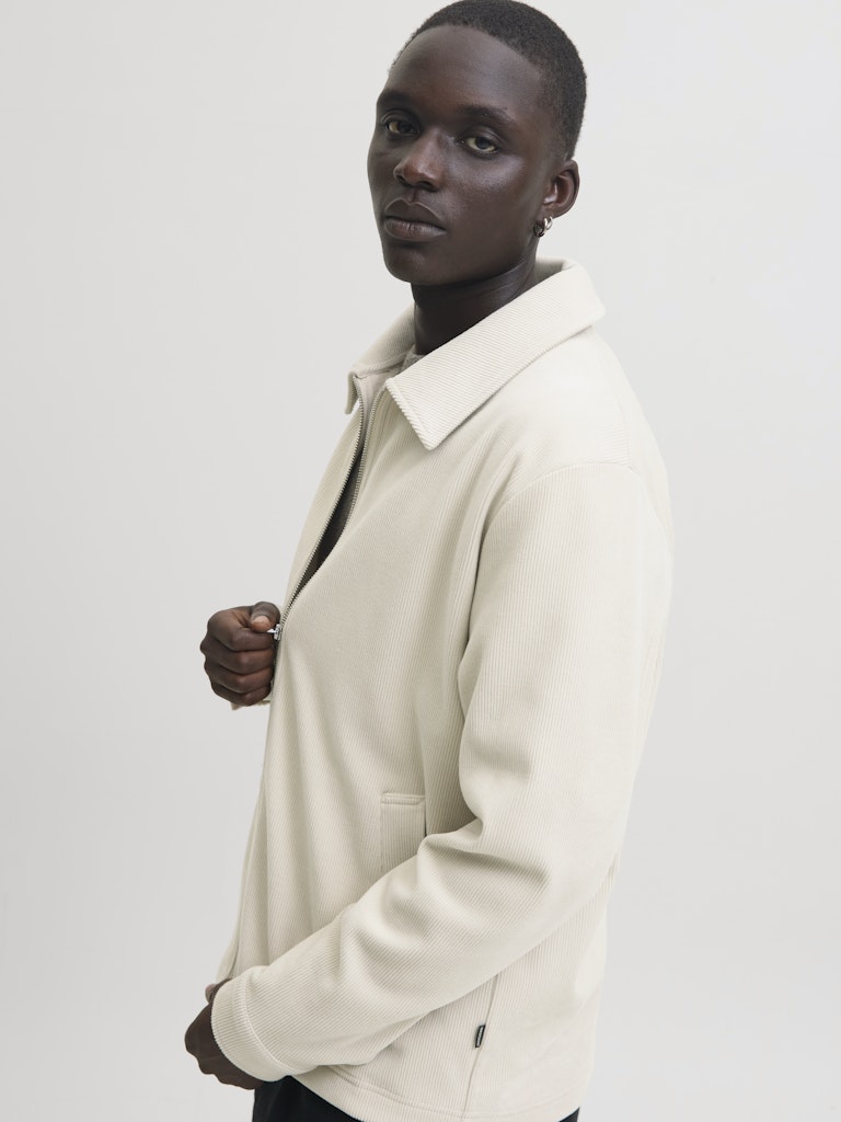 Man wearing a beige cardigan overshirt-Side view