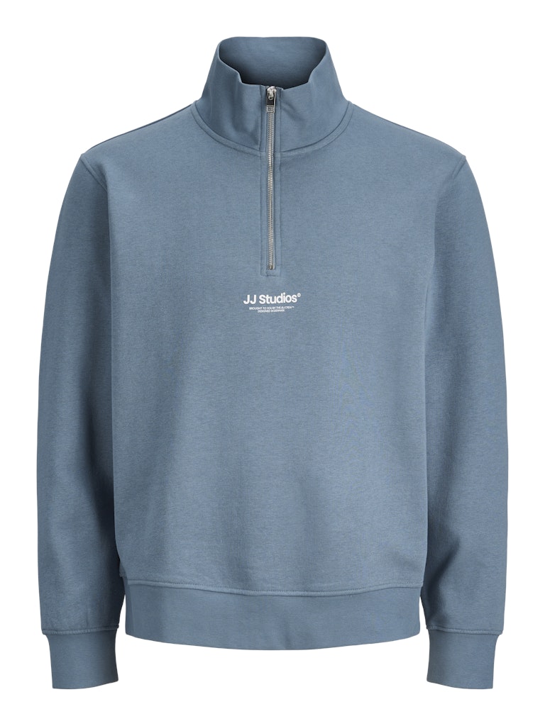 Blue sweatshirt with quarter zip and 'JJ Studios' logo on a white background