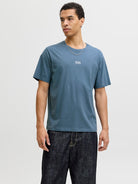 Man wearing a blue short sleeve tee with a jack & Jones logo on the chest