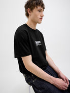 Almeria Branding Black Tee-Model sitting down view