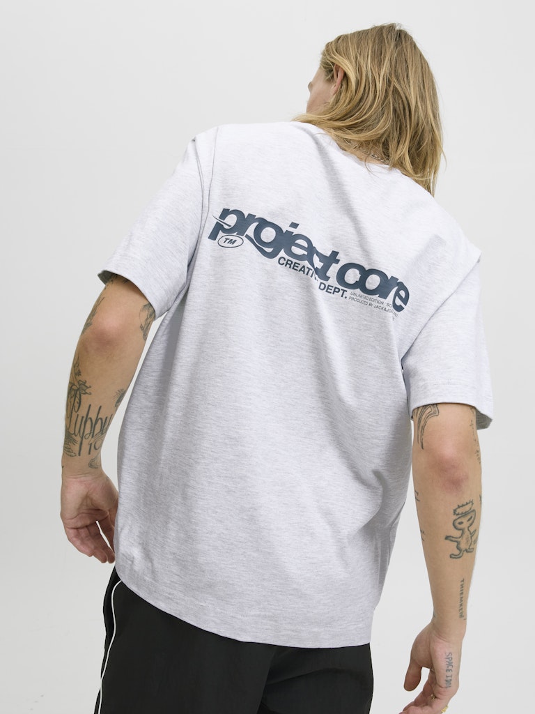 Person wearing a white t-shirt with 'project core' logo on the back, standing against a plain background.