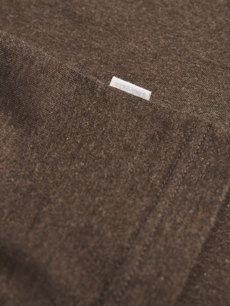 Close-up of a brown fabric with a small white label.