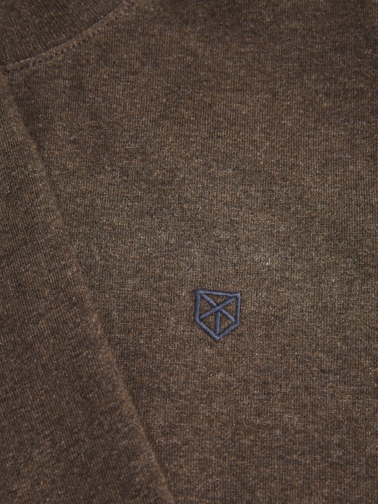 Close-up of a brown fabric with a blue embroidered logo