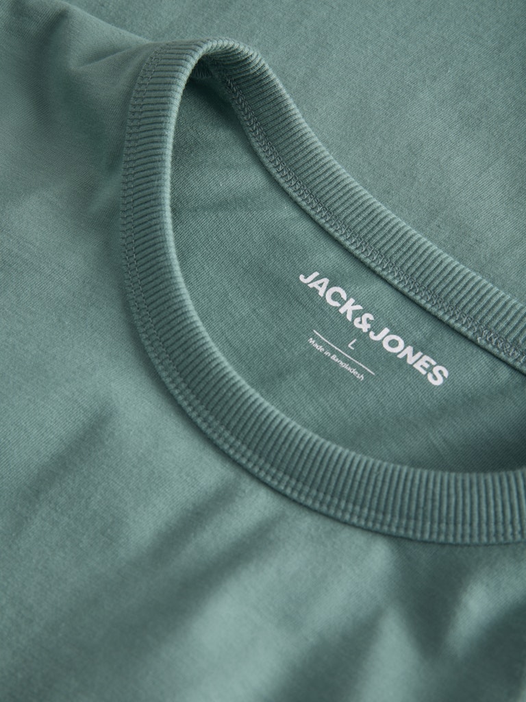 Close-up of a green t-shirt with 'Jack & Jones' logo on the collar.