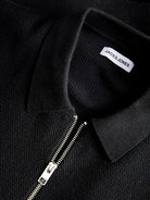 Black polo shirt with a zipper and 'Jack & Jones' label