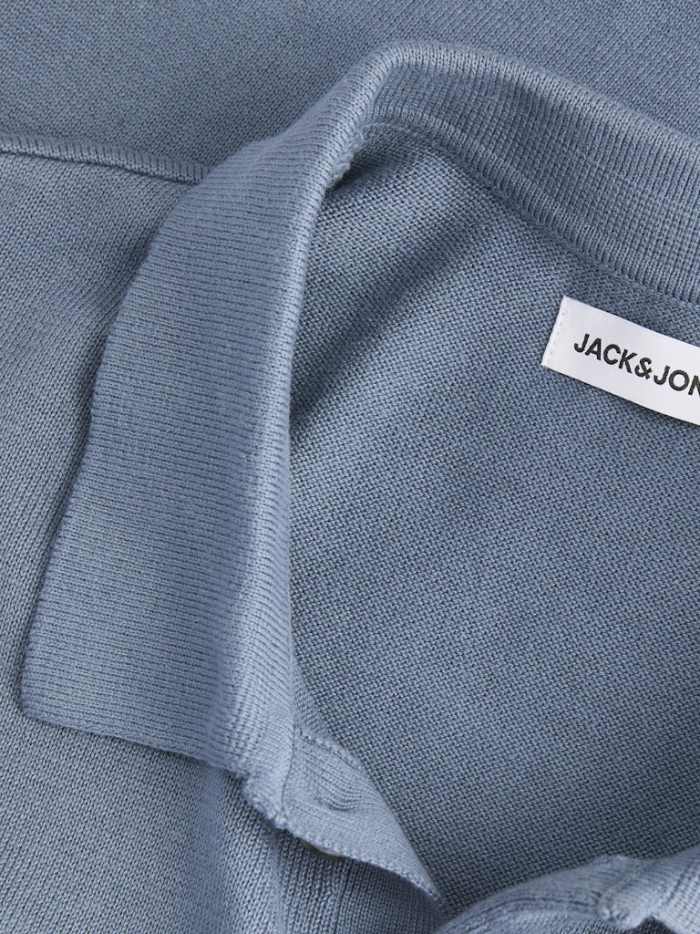 Close-up of a blue polo shirt with a 'Jack & Jones' label.