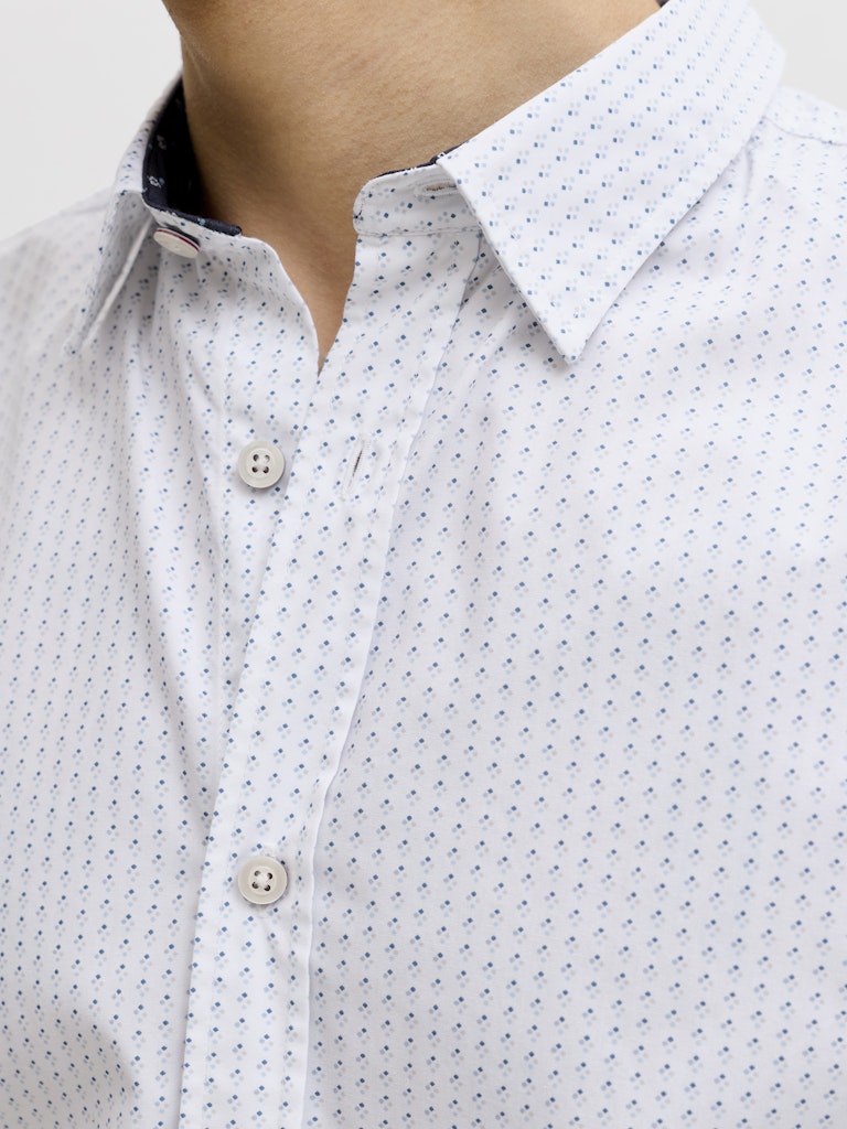 Close-up of a white shirt with black pattern and buttons
