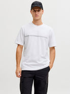 Person wearing a white t-shirt and black cap on a plain background