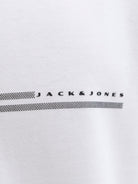 Close-up of a white shirt with 'Jack & Jones' logo on a light gray background