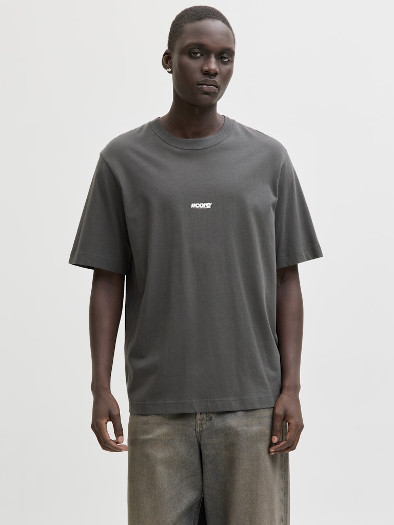 Man wearing a dark grey t-shirt with white 'CORE' logo