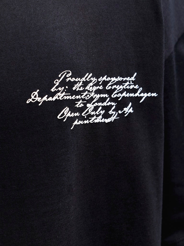 Black shirt with white printed text on a dark background