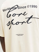 Yellow t-shirt with black text and branding on a person wearing it.
