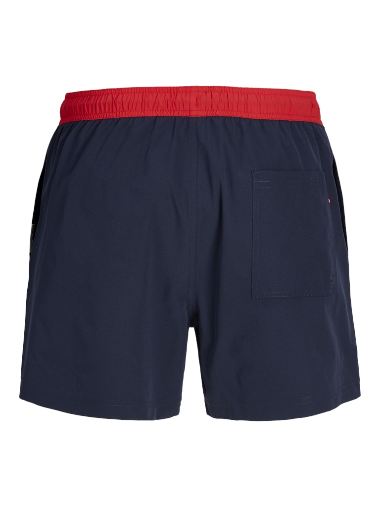 Navy swim shorts with a red waistband on a white background