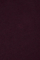 Close-up of Benetti Julius 1/4 Zip Knit in BORDO with textured knit fabric and embroidered logo.
