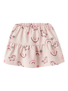 A light pink tiered baby skirt with an all-over print of unicorns, rainbows, and hearts in darker pink and green.