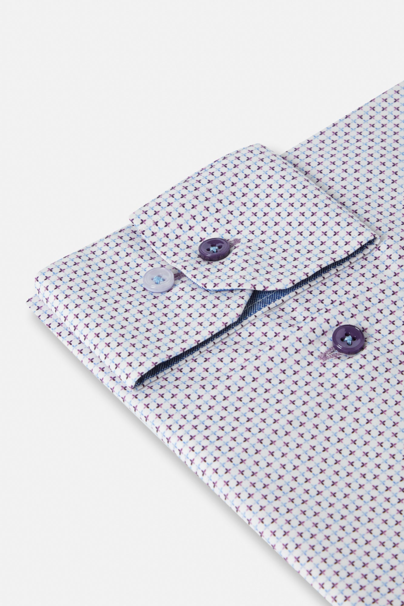 Close-up of a patterned shirt with buttons on a white background
