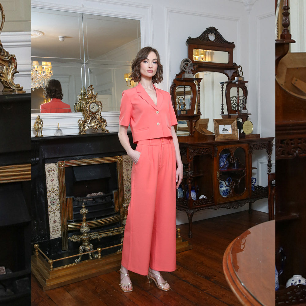 Model wearing coral blazer with trousers