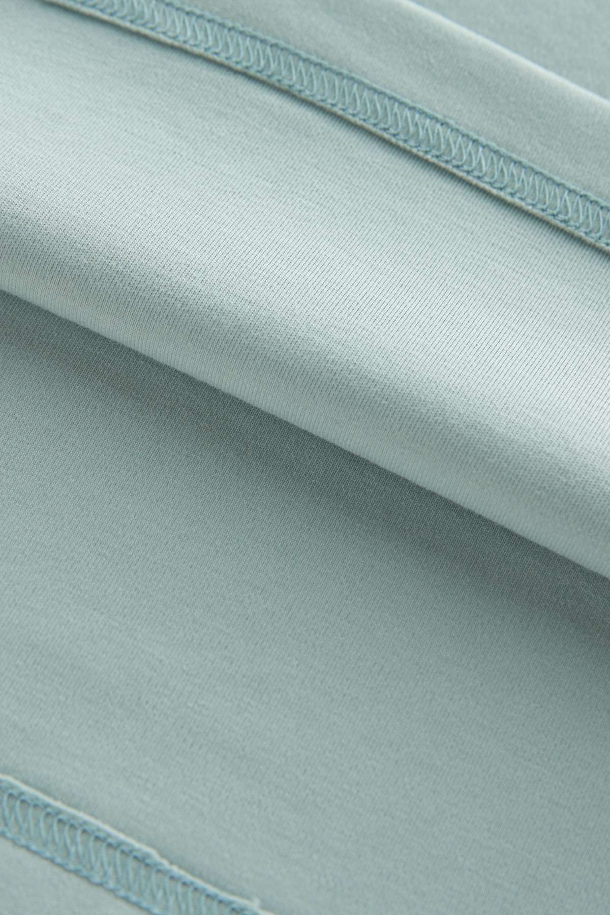 Close-up of light blue fabric with a subtle pattern