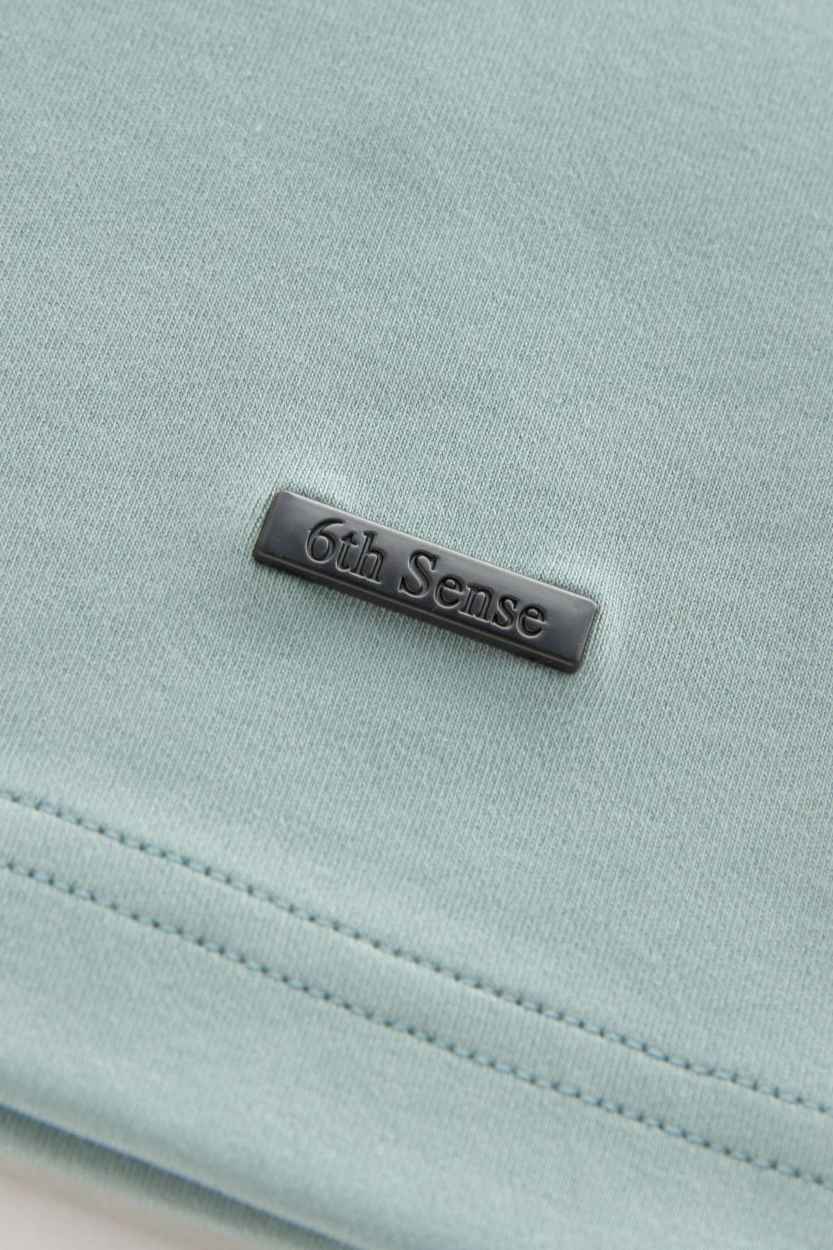 Light blue fabric with '6th Sense' label on a light gray background
