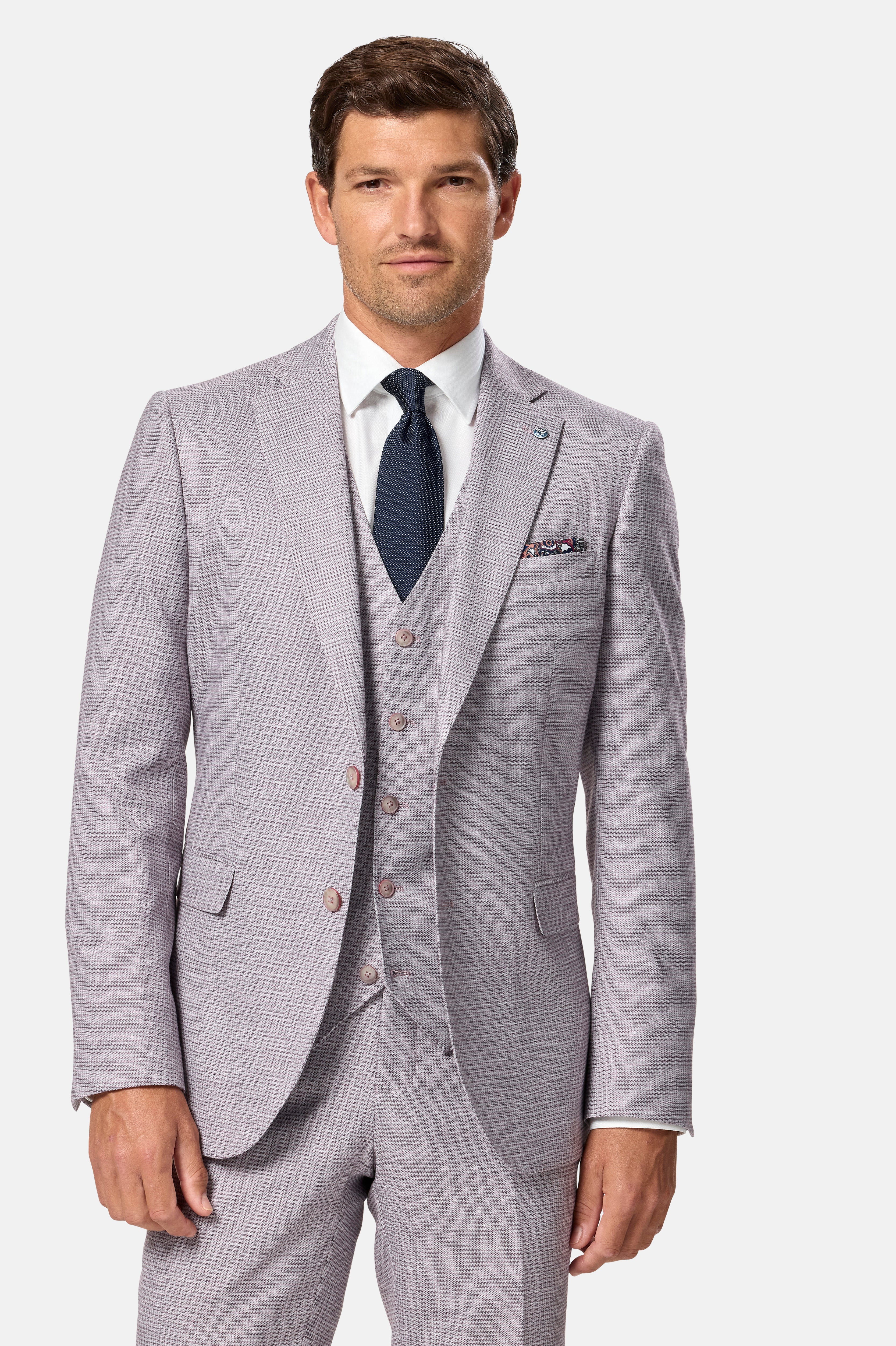 Man wearing ablush checkered suit with a white shirt and dark tie on a white background