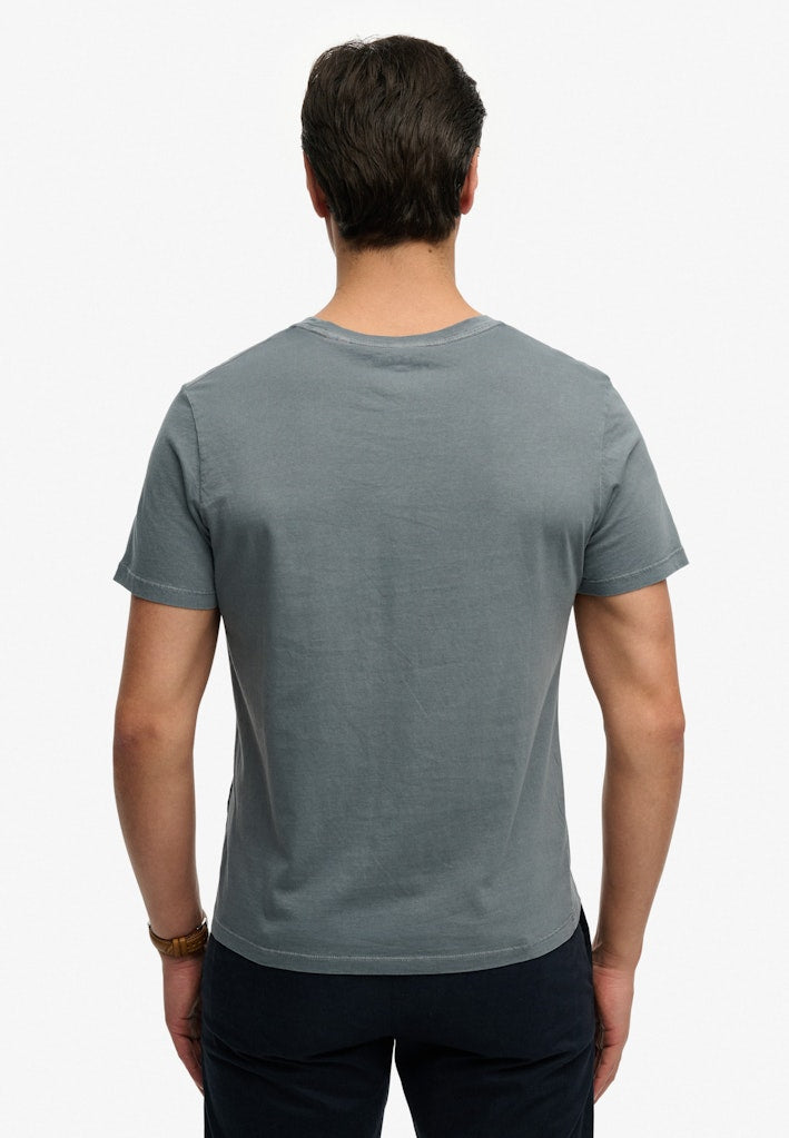 Model wearing  the Classic Essential Pocket Blue Mirage T-Shirt back view