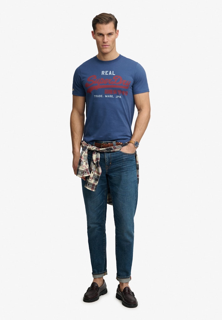 SUPERDRY vintage logo classic tee in hampton blue  front view model wearing jeans and shirt belt detail
