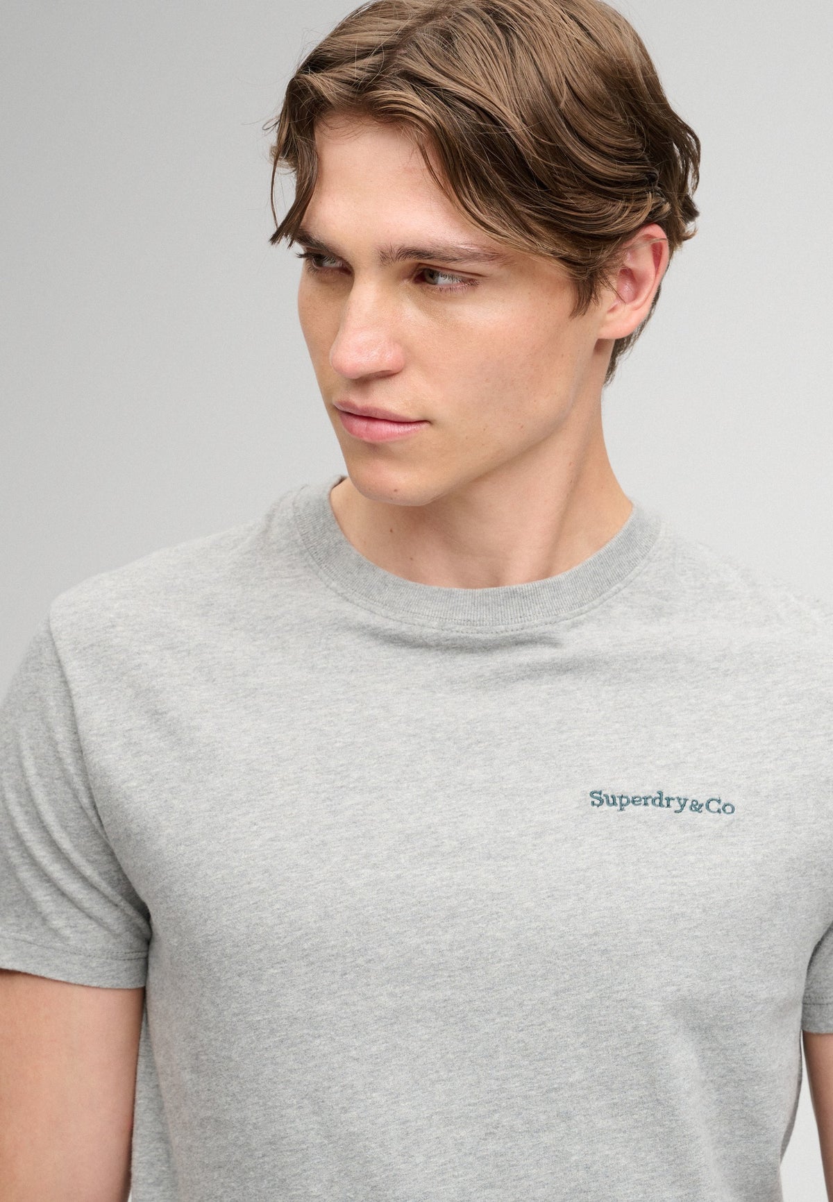 Superdry Essential Company Logo Tee in Sleet Grey Marl/Green angled view on model
