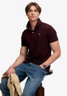 Superdry Vintage Destroy Polo in Winter Port seated model view