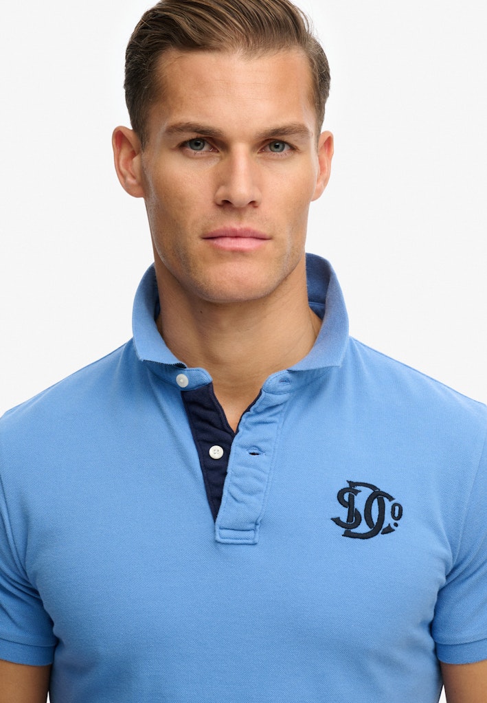 SUPERDRY Pique Monogram Polo Deep Blue Wave Eclipse Navy upper body front view detail