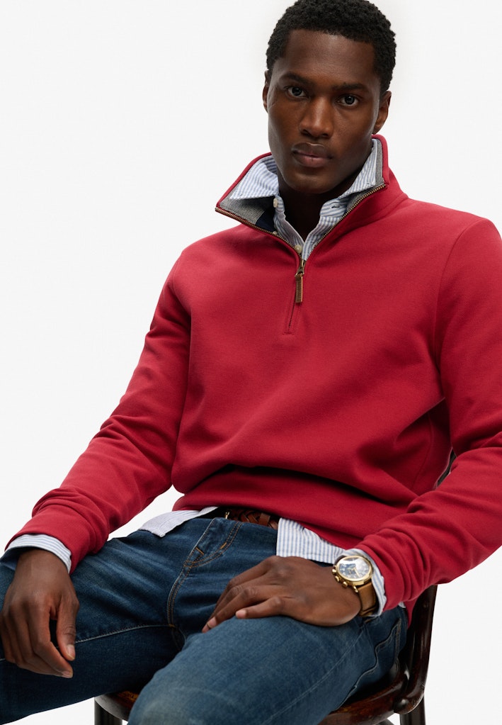 SUPERDRY Essential Pique Half Zip-Prep Red sweatshirt front view on seated model