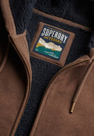 Superdry Borg Lined Ziphood in Mocha Brown Marl borg lining and patch detail