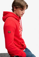 Superdry Vintage Logo Classic Hoodie in Indiana Red seated model view