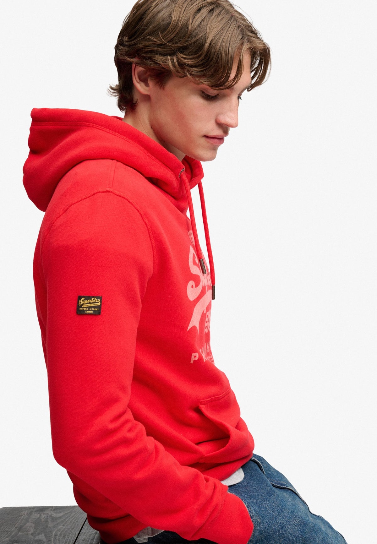 Superdry Vintage Logo Classic Hoodie in Indiana Red seated model view