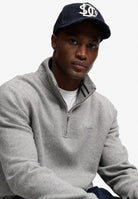 Superdry Essential Serif Logo Half Zip in Dark Vintage Grey Marl seated view