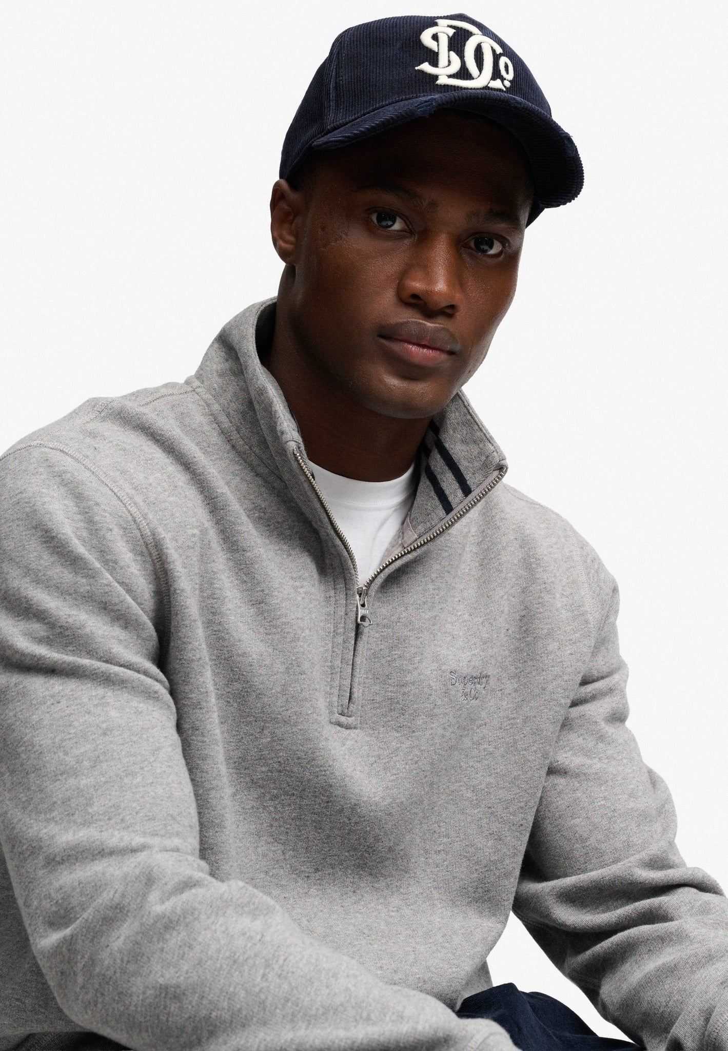 Superdry Essential Serif Logo Half Zip in Dark Vintage Grey Marl seated view
