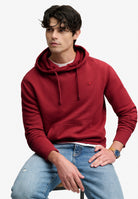 Superdry Essential Sdco Logo Hoodie in League Red seated model view