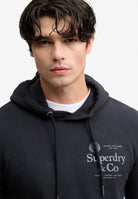 Superdry 1954 Company Relaxed Hoodie in Dark Navy upper body model view