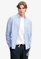 Superdry Preppy Oxford Long Sleeve Shirt in Azure Blue Chalk Stripe on model
