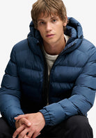 Superdry Hooded Sports Puffer Jacket in Altitude Blue seated model view