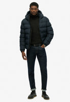 Superdry Hooded Sports Puffer Jacket - Eclipse Navy in Eclipse Navy/Eclipse Navy full length model view