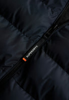 Superdry Hooded Sports Puffer Jacket - Eclipse Navy in Eclipse Navy/Eclipse Navy zip detail angled view