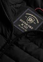 Superdry Fuji Midweight Padded Jacket in Jet Black zip and logo patch detail