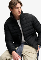 Superdry Fuji Midweight Padded Jacket in Jet Black seated model view