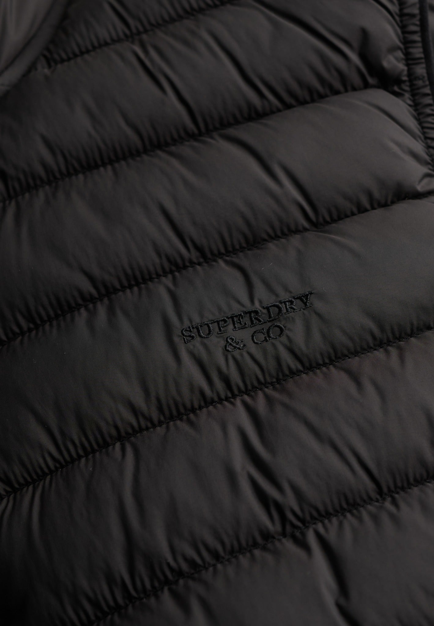 Superdry Fuji Lite Padded Gilet in Black logo detail
