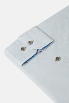 Folded sage green shirt with floral lining on a white background-Cuff sleeve detail