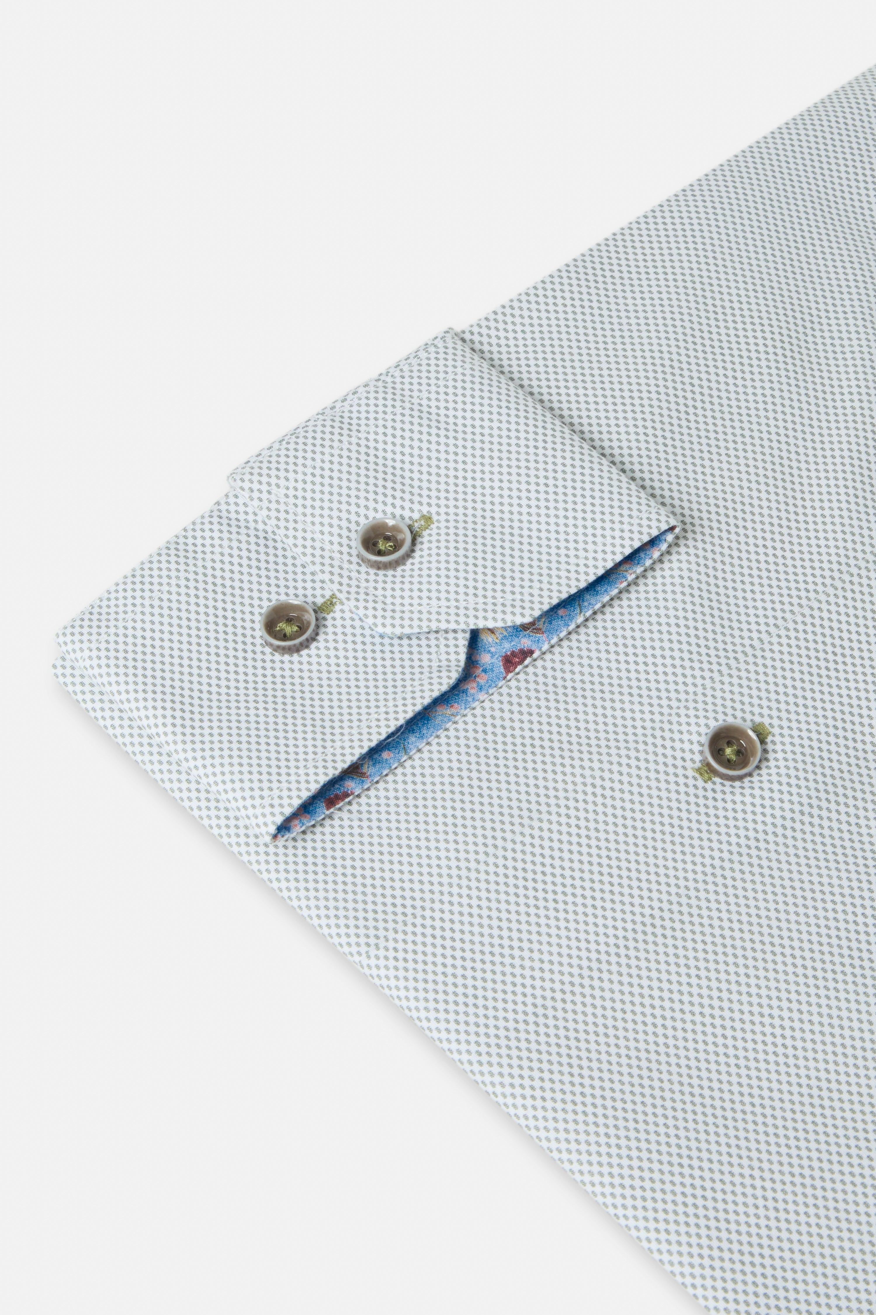 Folded sage green shirt with floral lining on a white background-Cuff sleeve detail