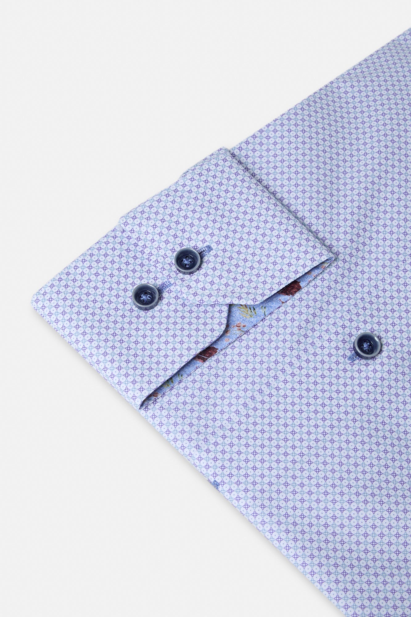 Close-up of a purple patterned shirt with a collar on a light background