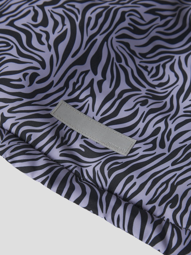 Zebra pattern fabric with a visible brand label on a white background